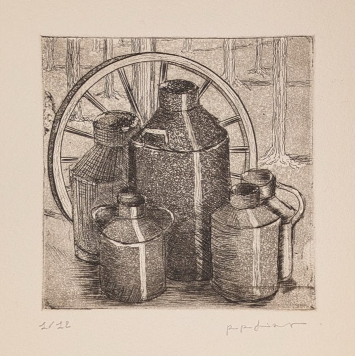 Souvenirs de Normandie, les pots de lait, bidons et roue devant des arbres